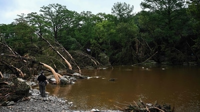 Police officers search for missing people near Camp Mystic, the site of where at least 20 girls went missing after flash flooding in Hunt, Texas, on July 5, 2025. (AFP) Police officers search for missing people near Camp Mystic, the site of where at least 20 girls went missing after flash flooding in Hunt, Texas, on July 5, 2025. (AFP)