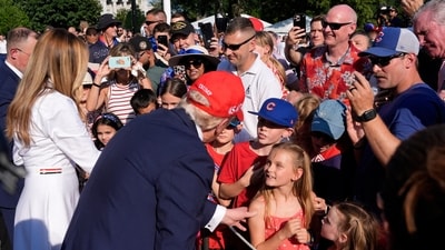 U.S. first lady Melania Trump and President Donald Trump greet active-duty military service members and their families during a Fourth of July celebration on the South Lawn of the White House in Washington, Friday, July 4, 2025.    Alex Brandon/Pool via REUTERS (via REUTERS)