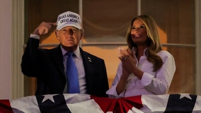 Trump gestures while first lady Melania Trump looks on as they stand at a balcony to watch the annual fireworks display during Fourth of July celebrations at the White House, in Washington, D.C., U.S., July 4, 2025. REUTERS/Ken Cedeno TPX IMAGES OF THE DAY (REUTERS)