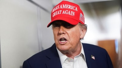 US President Donald Trump speaks to members of the media on board Air Force One on the way to New Jersey. (REUTERS)