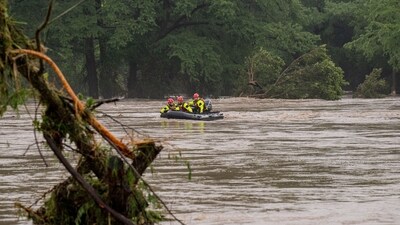 Boerne search and rescue teams navigate upstream in an inflatable boat on the flooded Guadalupe River in Texas (Getty Images via AFP) Boerne search and rescue teams navigate upstream in an inflatable boat on the flooded Guadalupe River in Texas (Getty Images via AFP)