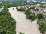 People look at the Guadalupe river, following flash flooding, in Kerrville, Texas
