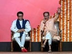 Shiv Sena (UBT) chief Uddhav Thackeray (R) waves to the crowd as his cousin and Maharashtra Navnirman Sena (MNS) president Raj Thackeray looks on before addressing a joint rally against the imposition of the Hindi language in primary schools, in Mumbai on July 5, 2025.