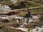 A Sheriff's deputy pauses while combing through the banks of the Guadalupe River near Camp Mystic after a flash flood swept through the area A Sheriff's deputy pauses while combing through the banks of the Guadalupe River near Camp Mystic after a flash flood swept through the area