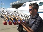 Jody Fischer, director of flight operations for a North Dakota-based cloud seeding business, adjusts flares used for a seeding on a plane Jody Fischer, director of flight operations for a North Dakota-based cloud seeding business, adjusts flares used for a seeding on a plane