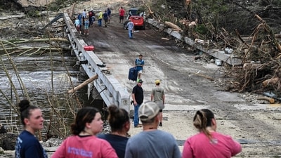 People look on as law enforcement and volunteers continue to search for missing people near Camp Mystic, the site of where at least 20 girls went missing after flash flooding in Hunt, Texas. (AFP/Ronaldo Schemidt) People look on as law enforcement and volunteers continue to search for missing people near Camp Mystic, the site of where at least 20 girls went missing after flash flooding in Hunt, Texas. (AFP/Ronaldo Schemidt)