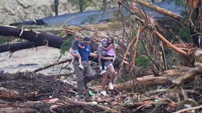 People climb over debris on a bridge atop the Guadalupe River after a flash flood swept through the area Saturday, July 5, 2025, in Ingram, Texas. (AP Photo/Julio Cortez) People climb over debris on a bridge atop the Guadalupe River after a flash flood swept through the area Saturday, July 5, 2025, in Ingram, Texas. (AP Photo/Julio Cortez)