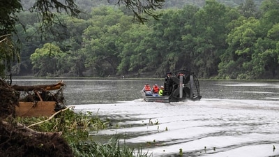 Men ride in an airboat on the Guadalupe River as they look for missing people in Hunt, Texas, on July 6, 2025, following severe flash flooding that occurred during the July 4 holiday weekend. (RONALDO SCHEMIDT / AFP) Men ride in an airboat on the Guadalupe River as they look for missing people in Hunt, Texas, on July 6, 2025, following severe flash flooding that occurred during the July 4 holiday weekend. (RONALDO SCHEMIDT / AFP)