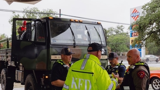 Members the Kerrville Fire Department and Texas Department of Public Safety refuel trucks after deadly flooding in Kerrville, Texas.(AP)