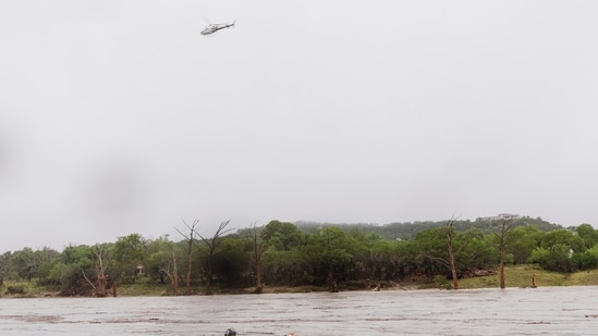 A helicopter flies over the Guadalupe River after a flash flood swept through the area in Kerrville, Texas.(AP)