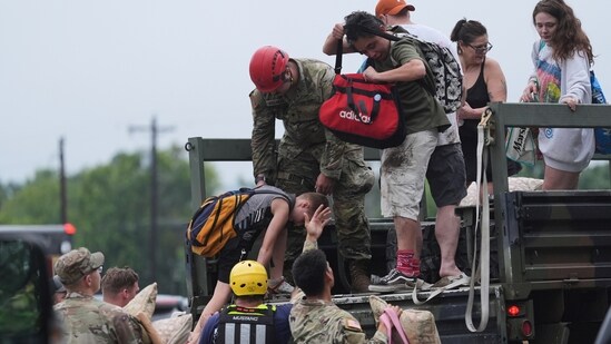 First responders deliver people to a reunification center after flash flooding in the area, Friday, July 4, 2025, in Ingram, Texas.(AP Photo/Eric Gay)