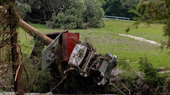 A large truck is impaled onto a tree after flash flooding on the bank Guadalupe River on July 5, 2025 in Center Point, Texas. Heavy rainfall caused flooding along the Guadalupe River in central Texas.(AFP)