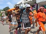 Kanwariyas (Shiva devotees) carry pots filled with water collected from Gangariver during the annual 'Kanwar Yatra'.