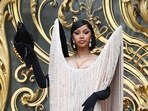 Cardi B showcases Schiaparelli's dramatic Fall 2025 collection, featuring a black fringe gown and a live crow. REUTERS/Abdul Saboor