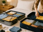 A modern traveller compares a hard case trolley bag and a soft case suitcase, ready to pack for the next big trip.
