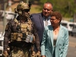 Los Angeles Mayor Karen Bass walks with a federal agent at MacArthur Park Monday, July 7, 2025, in Los Angeles. (AP Photo/Damian Dovarganes)