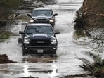 Trucks drive through a flooded and damaged road in Hunt, Texas, on July 6, 2025, following severe flash flooding that occured during the July 4 holiday weekend. (Photo by RONALDO SCHEMIDT / AFP) Trucks drive through a flooded and damaged road in Hunt, Texas, on July 6, 2025, following severe flash flooding that occured during the July 4 holiday weekend. (Photo by RONALDO SCHEMIDT / AFP)