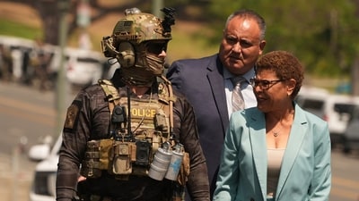 Los Angeles Mayor Karen Bass walks with a federal agent at MacArthur Park Monday, July 7, 2025, in Los Angeles. (AP Photo/Damian Dovarganes) (AP) Los Angeles Mayor Karen Bass walks with a federal agent at MacArthur Park Monday, July 7, 2025, in Los Angeles. (AP Photo/Damian Dovarganes) (AP)