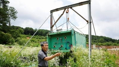 North Korean defector Lee Min-bok stands in front of a hydrogen tank he used to launch balloons carrying anti-Kim Jong Un leaflets. (Reuters)