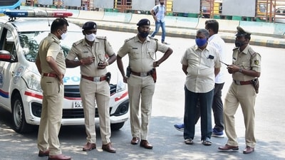 The Bengaluru police stand guard at BMTC bus stand, as coronavirus cases surge in Bengaluru, Wednesday (PTI) The Bengaluru police stand guard at BMTC bus stand, as coronavirus cases surge in Bengaluru, Wednesday (PTI)