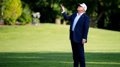 US President Donald Trump points to the new US flag, not pictured, on the South Lawn of the White House after arriving on Marine One in Washington, DC, US, on Sunday, July 6, 2025. (Bloomberg) US President Donald Trump points to the new US flag, not pictured, on the South Lawn of the White House after arriving on Marine One in Washington, DC, US, on Sunday, July 6, 2025. (Bloomberg)
