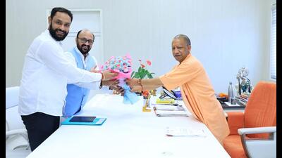 Uttar Pradesh higher education minister Yogendra Upadhyay (bespectacled) meeting CM Yogi Adityanath in Lucknow on July 7. (Sourced)