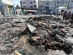 Palestinians inspect the site of an overnight Israeli strike on a school sheltering displaced people, in Bureij refugee camp, in the central Gaza Strip, July 8, 2025. 