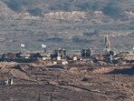 Israeli soldiers and military vehicles operate in Gaza, as seen from the Israeli side of the Israel-Gaza border