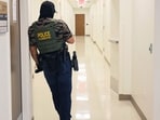 A federal agent waits in the hall at immigration court in the Ted Weiss Federal Building on July 07, 2025 in New York City.