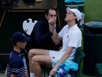 Italy's Jannik Sinner receives medical attention after sustaining an injury during his round of 16 match against Bulgaria's Grigor Dimitrov