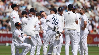 England's Chris Woakes with teammates as they look dejected after an unsuccessful DRS review for the LBW wicket (Action Images via Reuters)
