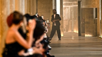 Rahul Mishra acknowledges the audience after presenting his creations during the Women's Haute-Couture Fall/Winter 2025-26 collection show. (AFP) Rahul Mishra acknowledges the audience after presenting his creations during the Women's Haute-Couture Fall/Winter 2025-26 collection show. (AFP)