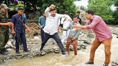 Himachal Pradesh Deputy Chief Minister Mukesh Agnihotri jumps over a water stream during his visit to cloudburst-affected village. (ANI) Himachal Pradesh Deputy Chief Minister Mukesh Agnihotri jumps over a water stream during his visit to cloudburst-affected village. (ANI)