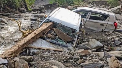 Vehicles stuck in debris at an area affected by the recent cloudburst and flash floods, in Mandi district. (PTI) Vehicles stuck in debris at an area affected by the recent cloudburst and flash floods, in Mandi district. (PTI)