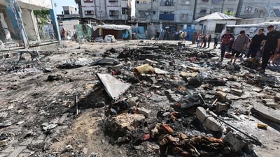Palestinians inspect the site of an overnight Israeli strike on a school sheltering displaced people, in Bureij refugee camp, in the central Gaza Strip, July 8, 2025. (REUTERS)