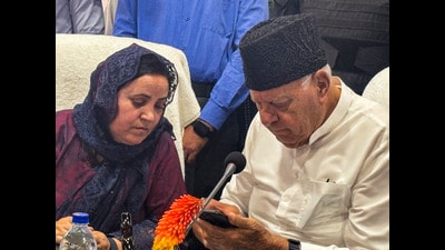 Jammu and Kashmir National Conference president Farooq Abdullah with state education minister Sakina Itoo during workers convention in Kulgam on Tuesday. (PTI)