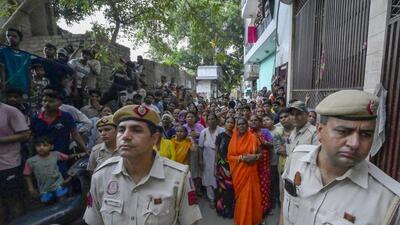 Police and neighbours in the locality where the woman and the infant was murdered on Tuesday. (RAJ K RAJ /HT PHOTO) Police and neighbours in the locality where the woman and the infant was murdered on Tuesday. (RAJ K RAJ /HT PHOTO)