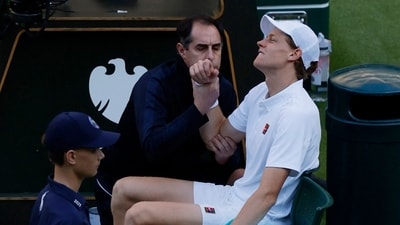 Italy's Jannik Sinner receives medical attention after sustaining an injury during his round of 16 match against Bulgaria's Grigor Dimitrov (REUTERS)