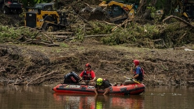 HUNT, TEXAS - JULY 7: Search and rescue workers use a sonar device while paddling down the Guadalupe River in a boat looking for survivors or the remains of victims swept up in the flash flooding on July 7, 2025 in Hunt, Texas. (Getty Images via AFP)