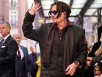 Johnny Depp poses upon arrival at the premiere of the film "Modigliani Three Days On The Wing Of Madness" on Tuesday