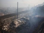 Smoke billows in L'Estaque district of Marseille, southern France on July 8, 2025, following a wildfire. A wildfire in southern France on July 8 forced Marseille airport to close and interrupted train traffic as the blaze spread rapidly to the edges of the southern French city. 