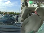 A cop breaking a car’s window to rescue children left inside the hot vehicle by their dad. A cop breaking a car’s window to rescue children left inside the hot vehicle by their dad.