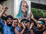 Students chant slogans near a vandalised mural of Bangladesh's ousted Prime Minister Sheikh Hasina, during a protest demanding accountability and trial against Hasina, near Dhaka University 