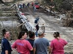 People look on as law enforcement and volunteers continue to search for missing people near Camp Mystic People look on as law enforcement and volunteers continue to search for missing people near Camp Mystic