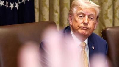 A reporter raises a hand to ask a question as US President Donald Trump attends a cabinet meeting at the White House in Washington, D.C. (REUTERS) A reporter raises a hand to ask a question as US President Donald Trump attends a cabinet meeting at the White House in Washington, D.C. (REUTERS)