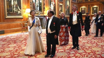 Britain's Princess Anne, Princess Royal (L) and Secretary General of the French Presidency Emmanuel Moulin (C) arrive to attend a State Banquet at Windsor Castle, west of London. (AFP) Britain's Princess Anne, Princess Royal (L) and Secretary General of the French Presidency Emmanuel Moulin (C) arrive to attend a State Banquet at Windsor Castle, west of London. (AFP)