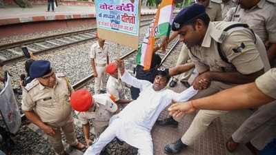 An agitator being detained during a protest by Congress workers and supporters amid 'Bihar bandh' called by the INDIA bloc against Special Intensive Revision in the state, at Sachiwalay Halt Railway station in Patna. (PTI)
