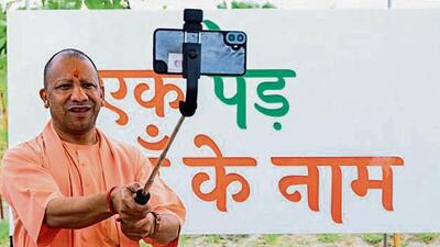 Chief minister Yogi Adityanath clicks selfie after planting a sapling under ‘Ek Ped Maa Ke Naam’ campaign, in Ayodhya on Wednesday. (PTI PHOTO)