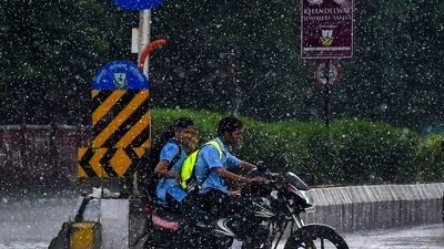 Nagpur rain: Commuters amid rainfall, in Nagpur, Maharashtra. (PTI) Nagpur rain: Commuters amid rainfall, in Nagpur, Maharashtra. (PTI)