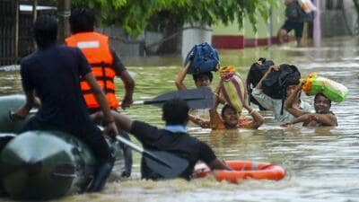 Rescue personnel assist locals in moving to a safer place through a rescue boat in a flood-affected area amid heavy rainfall on the outskirts of Agartala, Tripura. (PTI) Rescue personnel assist locals in moving to a safer place through a rescue boat in a flood-affected area amid heavy rainfall on the outskirts of Agartala, Tripura. (PTI)